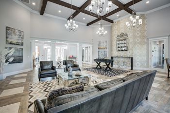 A large, modern living room with a dark leather couch and a fireplace.at Century Ariva, Florida  